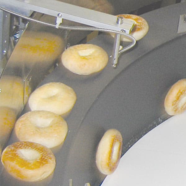 A collection of bagels in a steel drum.