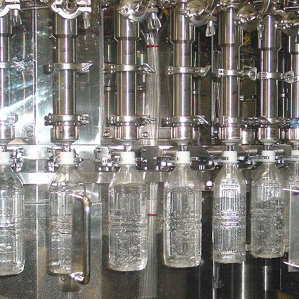 A collection of bottles in an assembly line.