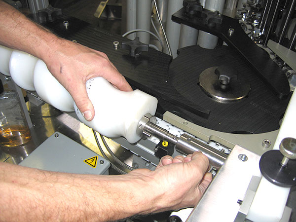 A technician replacing parts in a machine.