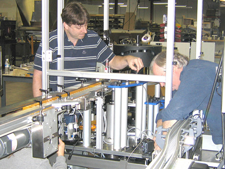Two technicians servicing a machine.